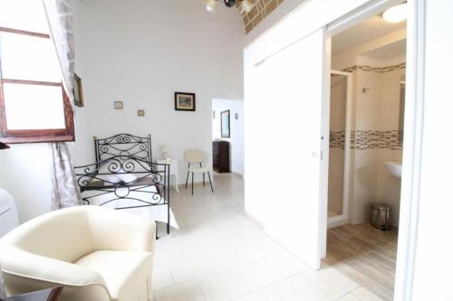 a living room with a chair and a table at Camera vista mare Holidayz in Gallipoli