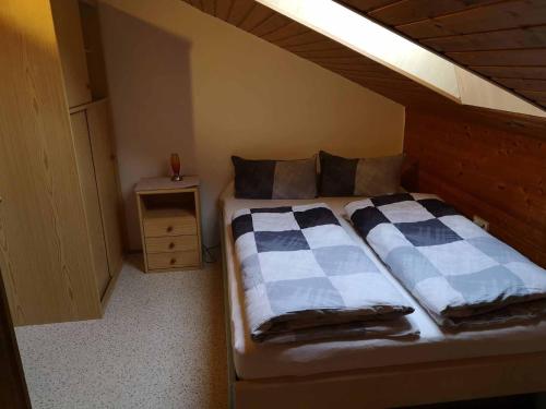 a bedroom with a bed with a wooden headboard at Ferienwohnungen Maintal in Karlstadt