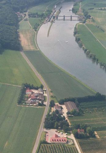 arial view of a river with houses and a bridge at Ferienwohnungen Maintal in Karlstadt