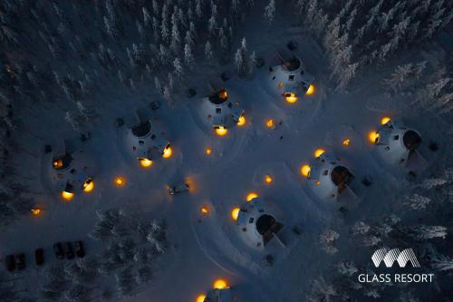 an aerial view of a resort in the snow at night at Glass Resort in Rovaniemi