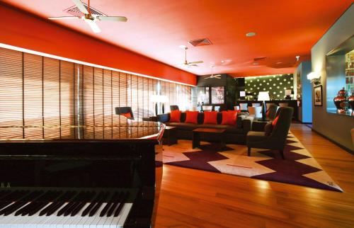 a living room with a piano and a couch at Hotel Casino Chaves in Chaves
