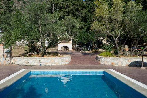 a swimming pool in the middle of a yard with trees at La Villa "Casa di Lydia" in Gavalochori