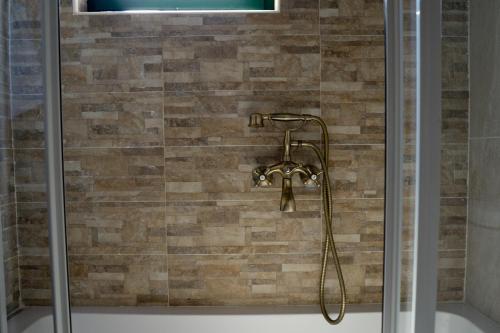 a shower with a shower head in a bathroom at La Villa "Casa di Lydia" in Gavalochori
