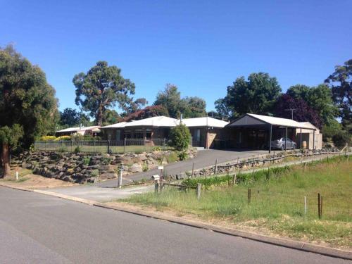 a view of a building with rocks and a road at Adelaide Hills Escape in Woodside