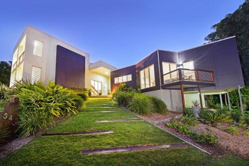 a house with a pathway leading to the front yard at Kilala - executive home in Port Macquarie