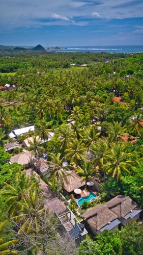 an aerial view of a resort with palm trees at Village Vibes Lombok in Kuta Lombok