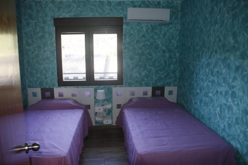 A bed or beds in a room at Casa Rural Las Pegueras