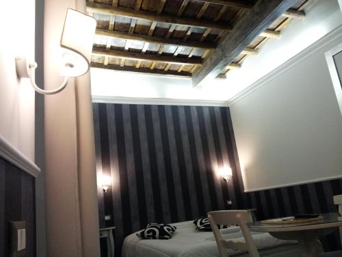a bedroom with a bed and a mirror and a chair at Navona Nice Room in Rome