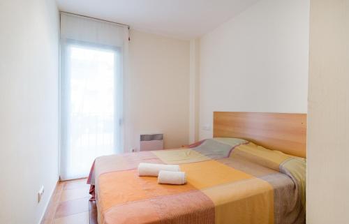 a bedroom with a bed with two towels on it at Canadell 1º 3ª in Palafrugell