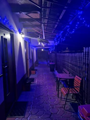 a room with purple lights and tables and chairs at O.W. Blue Cafe in Krościenko