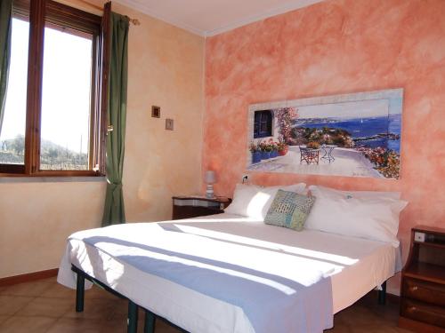 a bedroom with a bed and a large window at L' Arnia in Ome
