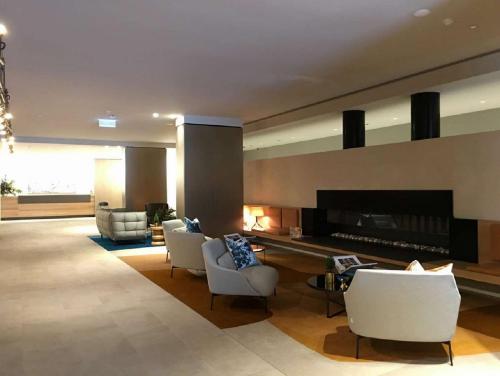 a living room with couches and a fireplace at Melbourne Private Apartments - Collins Wharf Waterfront, Docklands in Melbourne