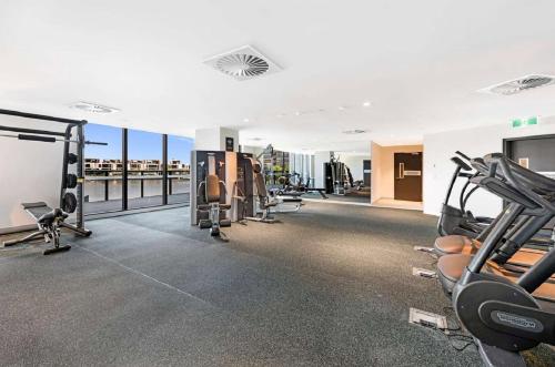 a gym with treadmills and cardio equipment in a building at Melbourne Private Apartments - Collins Wharf Waterfront, Docklands in Melbourne