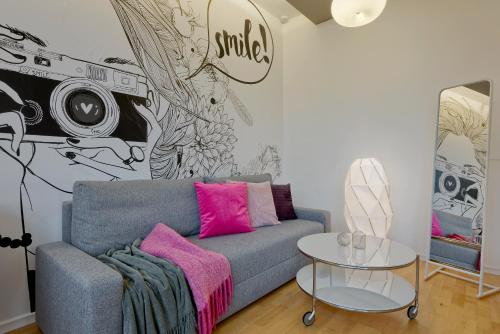 a living room with a couch and a camera mural at Loretańska Apartments 6 in Krakow