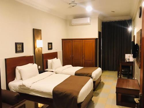 Кровать или кровати в номере Hotel One Jinnah, Islamabad