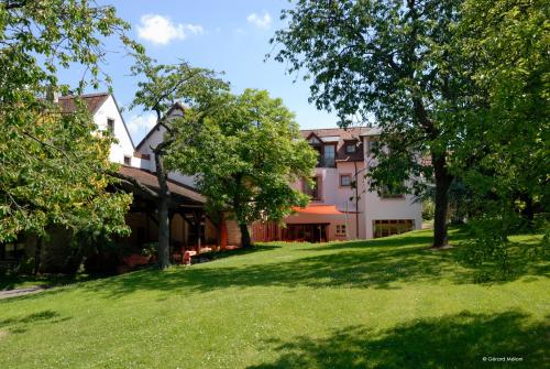 an image of a house with a yard at Auberge Saint Walfrid Hôtel Restaurant & Spa in Sarreguemines