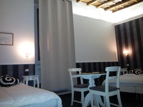 a bedroom with a bed and a table and chairs at Navona Nice Room in Rome