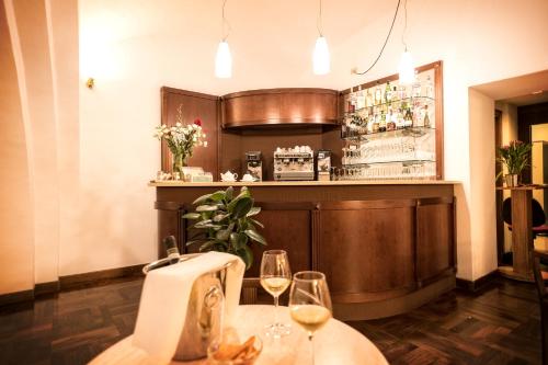 a bar with two wine glasses on a table at Grand Hotel Italia in Orvieto