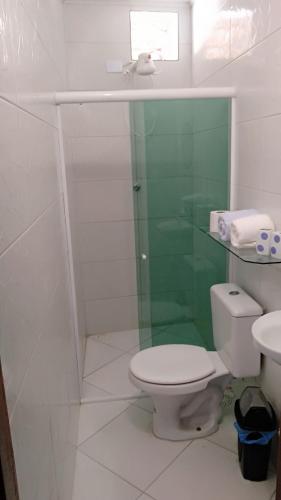 a bathroom with a toilet and a glass shower at Pousada Don'Ana in Conde