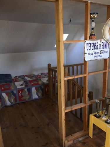 a bedroom with a bunk bed with a sign on it at FACE A LA MER , L ARTISTE in Ambleteuse