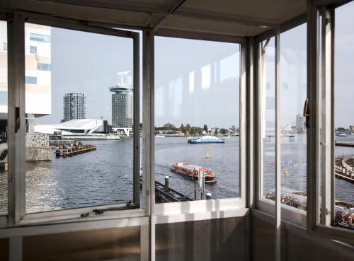 a view of a river from a window at SWEETS - Westerdoksbrug in Amsterdam