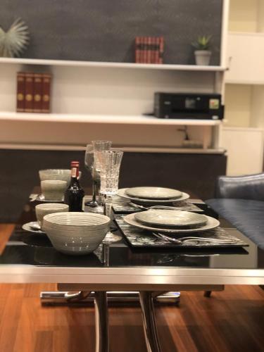 a table with plates and bowls on top of it at Parisian Studios design by KENZO in Paris
