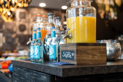 a table with bottles of orange juice on it at HARBR. hotel Heilbronn in Heilbronn