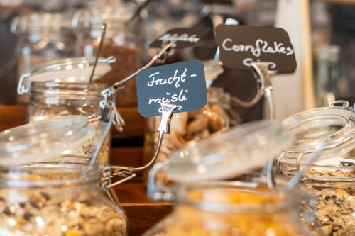 a group of jars filled with food on a table at HARBR. hotel Heilbronn in Heilbronn