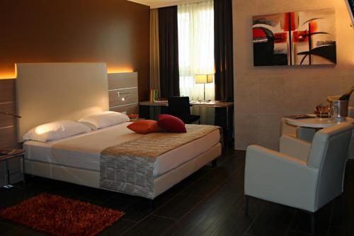 a hotel room with a bed and a desk at Best Western Plus Soave Hotel in San Bonifacio