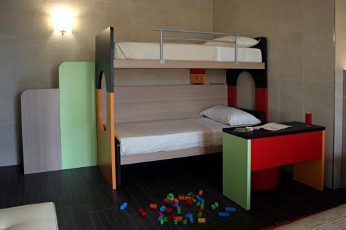 a room with two bunk beds and a table at Best Western Plus Soave Hotel in San Bonifacio