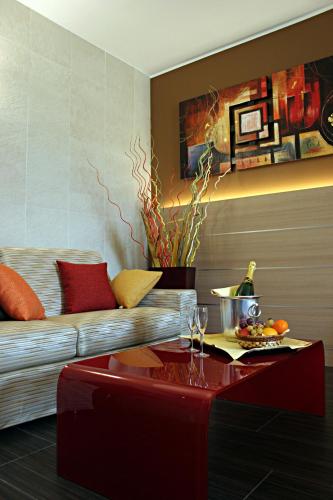 a living room with a couch and a table at Best Western Plus Soave Hotel in San Bonifacio