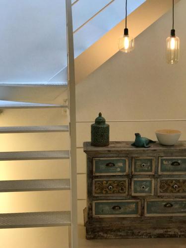 a room with a wooden dresser and a staircase at Sa caseta Farinera in Sóller