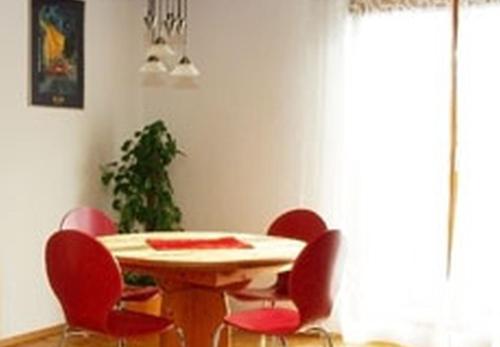 a table and chairs in a room with a table and a plant at Haus Widenhorn in Sipplingen