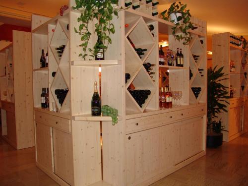 a wine tasting room with a wall of wine bottles at Best Western Plus Soave Hotel in San Bonifacio