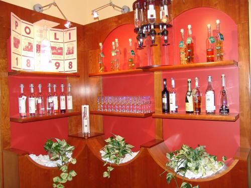 a bar with lots of bottles of wine on shelves at Best Western Plus Soave Hotel in San Bonifacio