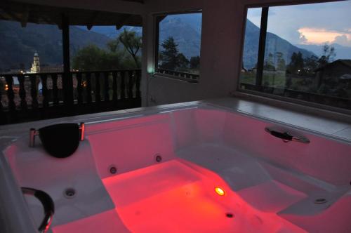 a hot pink bath tub in a room with windows at La Posada Campestre Cabañas in El Cocuy