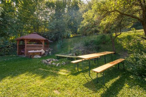 two benches and a gazebo in a park at Penzión Príjemný Oddych in Banská Štiavnica