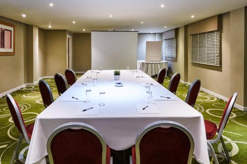 a conference room with a large white table and chairs at Mercure Newbury West Grange Hotel in Thatcham