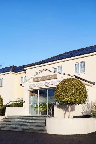 a white building with stairs in front of it at Mercure Newbury West Grange Hotel in Thatcham