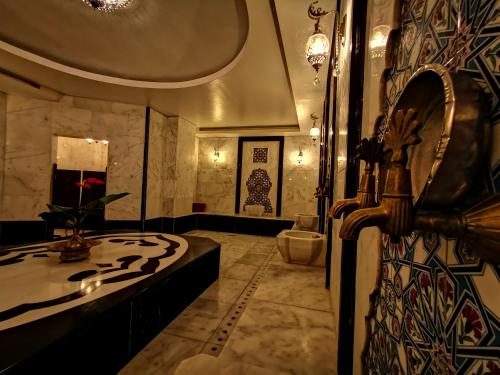 a large bathroom with a tub and a sink at White Park Hotel in Sarıkamıs