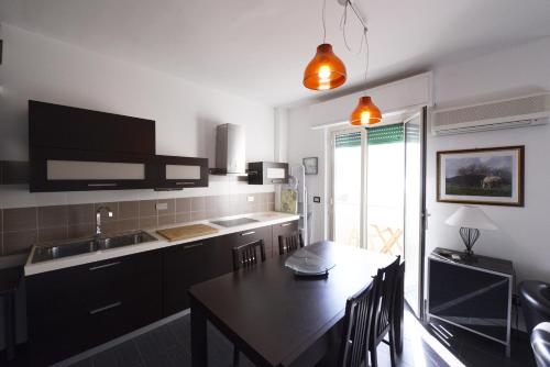 a kitchen with a table and a dining room at Casa sul mare in Isola delle Femmine