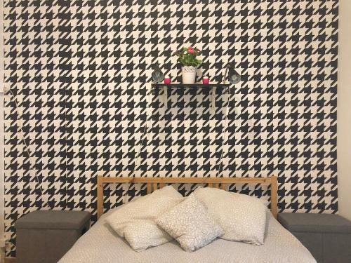 a bedroom with a black and white patterned wall at Luz Soriano Apartment in Lisbon