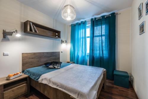 Een bed of bedden in een kamer bij Apartament WILDA