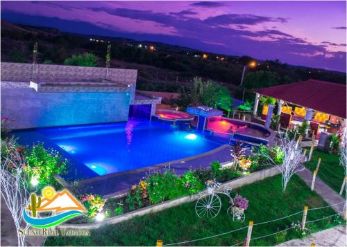 a large swimming pool in a yard at night at HV Sueño Real Tatacoa in Villavieja