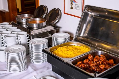 a buffet with plates and bowls of food on a table at BS-Ötscher Hotel in Lackenhof