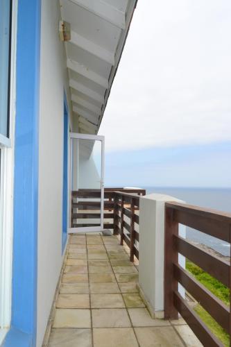 a balcony of a house with the ocean in the background at Nine-ohh Skuitbaai in Eersterivierstrand