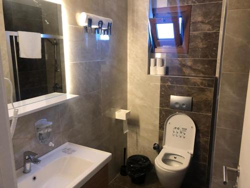 een kleine badkamer met een toilet en een wastafel bij Luxx Suite Mecidiyeköy in Istanbul