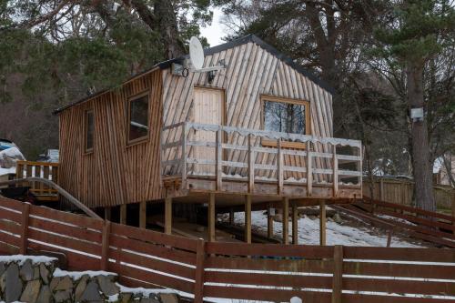 a house is being built on a deck at Pine Marten Bar Glenmore Treehouse in Aviemore