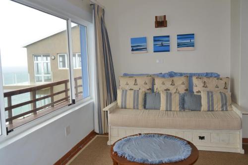 a bedroom with a bed and a large window at Nine-ohh Skuitbaai in Eersterivierstrand
