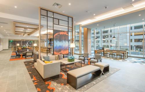 an office lobby with couches and tables at Hyatt House Nashville at Vanderbilt in Nashville